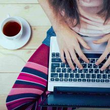 Teen girl sitting with a laptop